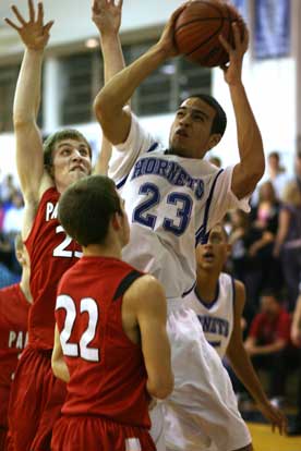 Bryant's K.J. Hampton, 23, shoots over Cabot's Darin Jones and Christian Armstrong. Hampton led the team with 10 points. (Photo by Rick Nation)