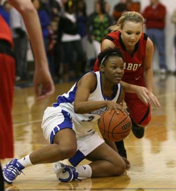 Lady Hornet Alana Morris keeps her dribble alive after falling to the floor. (Photo by Rick Nation)