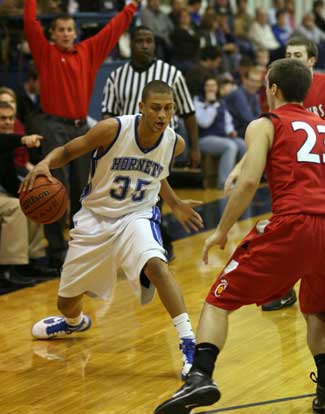 Bryant's Dontay Renuard (35) looks for room against Cabot's Alex Baker. (Photo by Rick Nation)