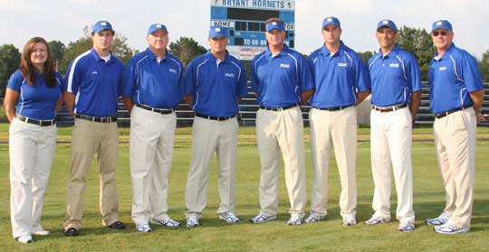 Dale Jones, fourth from left, along with the 2009 Bryant Hornets football staff, from left, trainer Christa Finney, Brandon Butler, Brad Stroud, Jones, head coach Paul Calley, Jason Hay, John Wells and Steve Griffith. (Photo by Rick Nation)