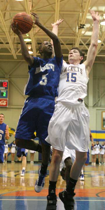 K-Ron Lairy (5) shoots over Sheridan's Collin Simpson (15). (Photo by Rick Nation)