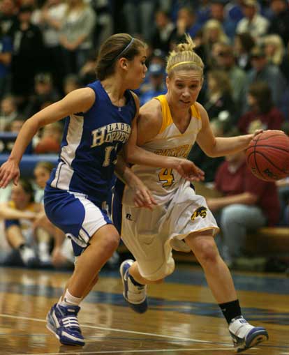 Haley Montgomery (11) applies tight defensive pressure on Sheridan point guard Mycah Love (4). (Photo by Rick Nation)