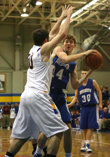 Bryant's Quinton Motto looks for room past Sheridan's Kyle Spann. (Photo by Rick Nation)