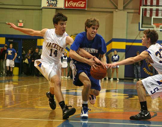 Bryant guard Brandon Parish (2) tries to drive between a pair of Sheridan defenders Nick Ware (14) and Blake Gibbs. (PHoto by Rick Nation)