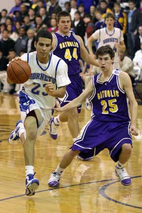 K.J. Hampton tries to drive around Catholic's Sam Atkinson. (Photo by Rick Nation)