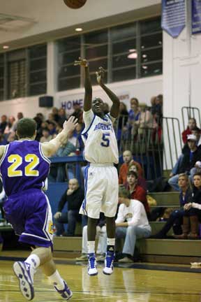 K-Ron Lairy (5) fires a shot over Catholic's Brad Kiernan. (Photo by Rick Nation)