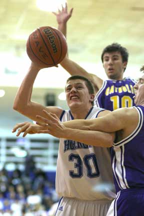 Bryant's L.J. McLaughlin tries to muscle up a shot through the arms of Little Rock Catholic defenders. (Photo by Rick Nation)