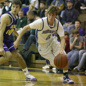 Brandon Parish (2) drives around Catholic's Marco Piccinini. (Photo by Rick Nation)