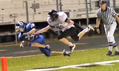 Dylan Holland (28) gets knocked out of bounds by a Bauxite defender. (Photo by Kevin Nagle)