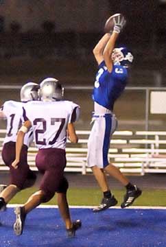 Devon Sears (3) hauls in a touchdown pass in front of Benton's Darcy Perry (27). (Photo by Kevin Nagle)
