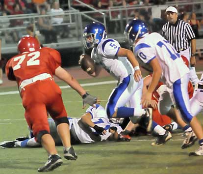 Bryant quarterback Wesley Akers (5) scrambles upfield as teammate Tanner Rich (70) tries to get in position to help out against Cabot's Heath Pledger (72). (Photo by Kevin Nagle)