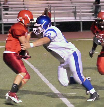 Cabot quarterback Kason Kimbrell braces for impact from Bryant's Jimmy McCann. (Photo by Kevin Nagle)