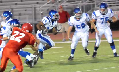 Bryant's Madre London (14) picks up a block from Austin Miller on Cabot's Zach Launius (22) while linemen Jacob Ward (59) and Jordan Jones (76) move into action. (Photo by Kevin Nagle)