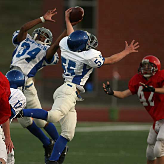 Nic Jenkins (55) and Brushawn Hunter (34) battled for a Cabot North pass during Thursday's game. (Photo by Rick Nation)