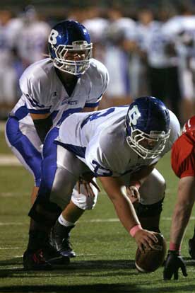 Hayden Lessenberry takes a snap from center Justin Rauch. (Photo by Rick Nation)