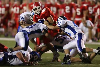 Bryant's Hunter Mayall (18), Ben Seale (52) and Cameron Price (41) stack up a Cabot runner. (photo by Rick Nation)