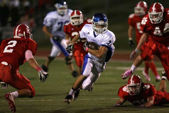 Bryant's Sawyer Nichols cuts upfield past Cabot's Zach Berry (2) and Riley Hawkins (44). (Photo by Rick Nation)