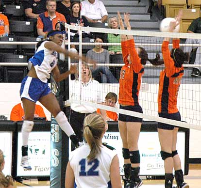 Bryant's Breanna White, left, recoils after going high for a spike on Tuesday. (Photo by Mark Hart)