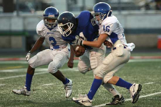 Bryant's Drew Tipton (16) and Mar'Kevius Nelson (2) wrestle down Conway Carl Stuart running back Terrence Minor. (Photo by Rick Nation) Bryant's Drew Tipton (16) and Mar'Kevius Nelson (2) wrestle down Conway Carl Stuart running back Terrence Minor. (Photo by Rick Nation)