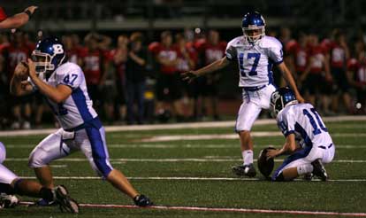 Jace Denker (17) kicks out of the hold of Caleb Garrett (10) while Jon Reed (47) and the rest of the Hornets special team hold out the rush. (Photo by Rick Nation)