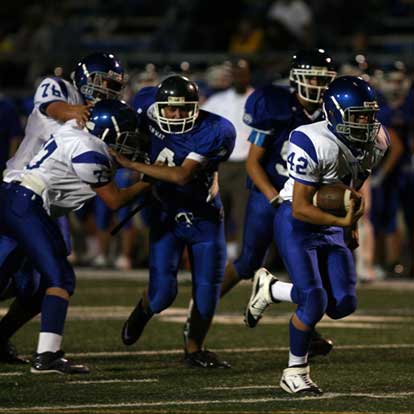 Colton Burton heads to the end zone on his touchdown run after being sprung by blocks from Jordan Jones (76) and Colton Caviness (77). (Photo by Rick Nation)