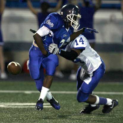 Madre London (14) makes the tackle and strips the ball from the arms of Gerrett Williamson (7) on Thursday's opening kickoff. (Photo by Rick Nation)