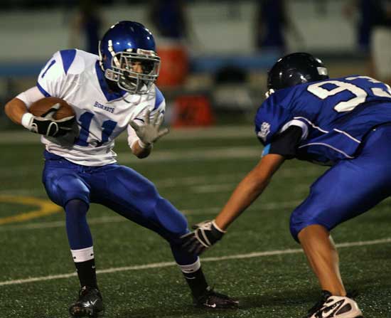 Bryant's Austin Miller (11) caught two touchdown passes at Conway on Thursday. Here he tries to get past Conway White's Dylan Crossley (93). (Photo by Rick Nation)