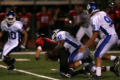 James Kidd brings down a Russellville ball carrier as Josh Hampton (98) and Dylan Blasi converge. (Photo by Rick Nation)