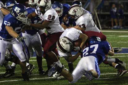 Bryant's Jacob Brady (27) brings down Springdale's Joseph Calcagni as Ben Seale (52) gets free to help out. (Photo by Rick Nation)