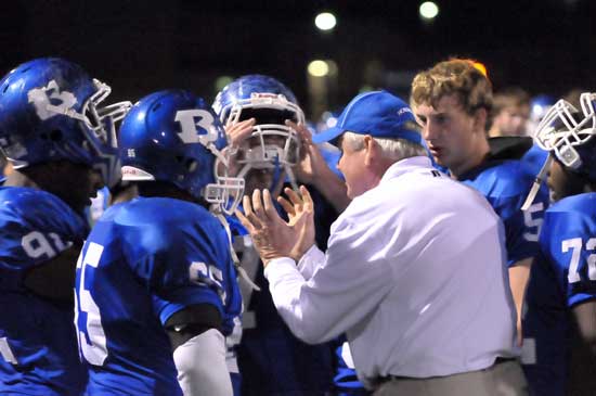 Defensive line coach Brad Stroud exhorts a group of Hornet defenders during a break in Friday night's action. (Photo by Kevin Nagle)