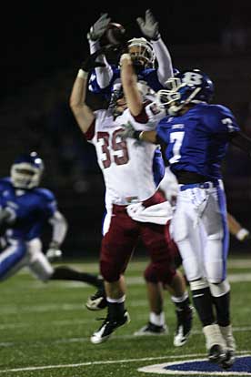 Bryant's Aaron Bell (7) and Caleb Thomas fight Springdale's Keenan Sanchez (39) for a pass. (Photo by Rick Nation)