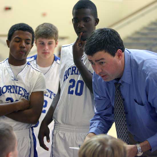 Bryant Hornets freshman coach Steve Wilson visits with his team during a timeout. (Photo by Rick Nation)