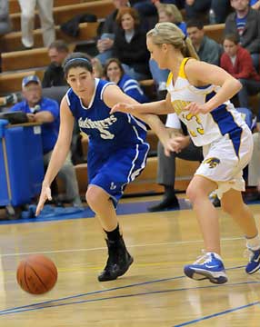 Bryant's London Abernathy (5) tries to drive around Sheridan's Amber Weigand. (Photo by Kevin Nagle)