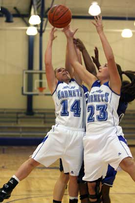 Caylin Choate (14) and Aubree Allen (23) battle for a rebound. (Photo by Rick Nation)