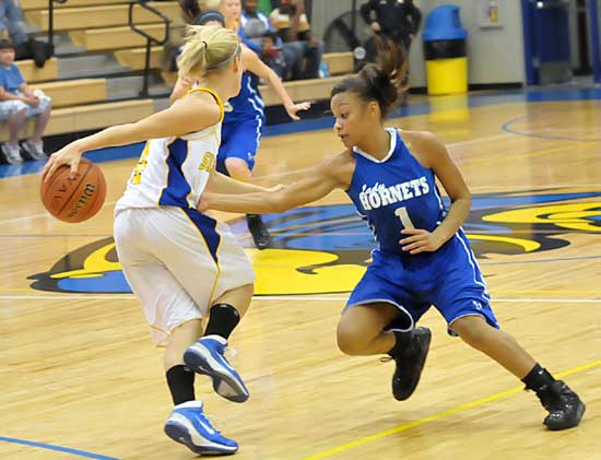 Bryant's Kiara Moore (1) defends against Sheridan's Mycah Love (4). (Photo by Kevin Nagle)