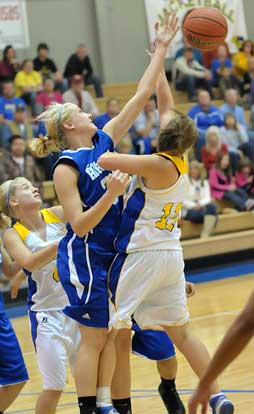 Abbi Stearns, middle, goes up for one of her 15 rebounds in Tuesday's game. (Photo by Kevin Nagle)