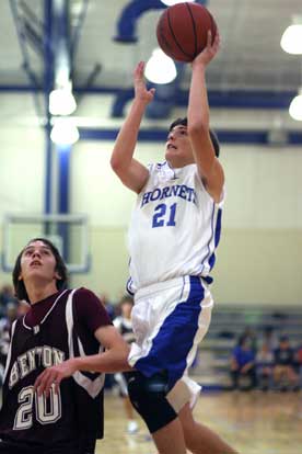 Bryant's Caleb Strain (21) puts up a shot during Thursday's game against Benton. (Photo by Rick Nation)