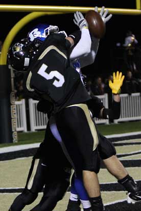 Bryant's Stephen Clark gets hammered by Bentonville's Dallas Coleman (5) on a pass into the end zone. (Photo by Rick Nation)