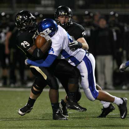 Bryant's Josh Hampton (98) smacks Bentonville running back Tearis Wallace (29). (Photo by Rick Nation)