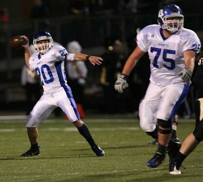 Tanner Tolbert (20) winds up to throw a pass on a trick play as Austin Johnson (75) protects. (Photo by Rick Nation)
