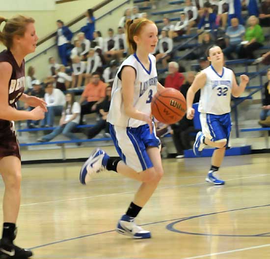 Nikki Clay pushed the ball up the floor while teammate Jamie Jamison (32) fills the wing against Benton Monday night. (Photo by Kevin Nagle)