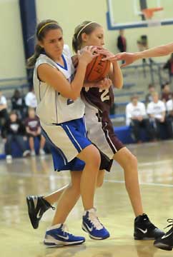 Allison Hughes, left, ties the ball up for Bryant. (Photo by Kevin Nagle)