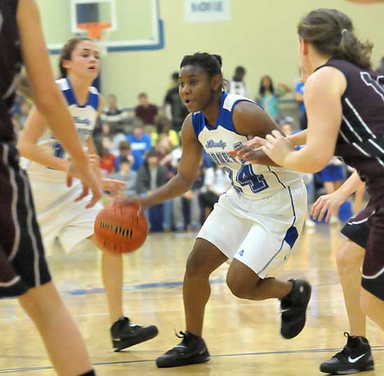 Bryant's Dezerea Duckworth drives past teammate Andrea Buford (12) and a Benton defender. (Photo by Kevin Nagle)