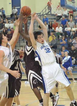 Bryant's Mitch Scoggins (32) battles for one of his game-high 10 rebounds. (Photo by Kevin Nagle)