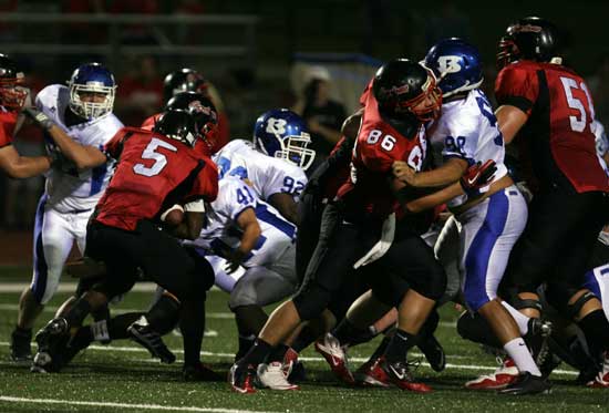 Bryant's James Kidd (92), Cameron Price (41) and Josh Hampton (98) battle against Russellville in a game earlier this season. (PHoto by Rick Nation)