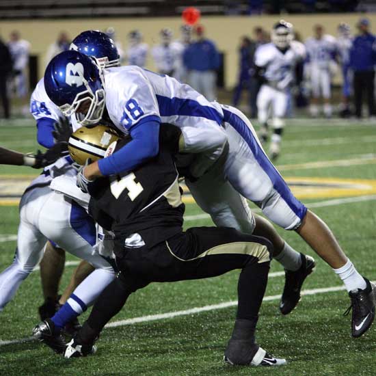 Josh Hampton (98) lowers the boom on Marvell Harris. (Photo by Rick Nation)