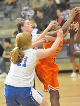 Taylor Lindberg and Miranda Lawrence (11) battle for a rebound. (Photo by Kevin Nagle)