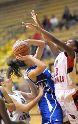 McKenzie Adams, middle, goes up for a shot around Camden Fairview's Jermaka Marks. (Photo by Kevin Nagle)