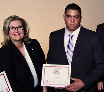 State Farm Awards Class 7A/6A Defensive Player of the Year finalists were honored at a banquet at the Aerospace Education Center in Little Rock on Monday, Dec. 13. Pictured (from left) are State Farm Agent Shawn Chatin and Bryant’s Josh Hampton. (Photo by Nelson Chenault)