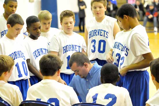Bryant White coach Heath Long instructs his team during a timeout. (Photo by Kevin Nagle)